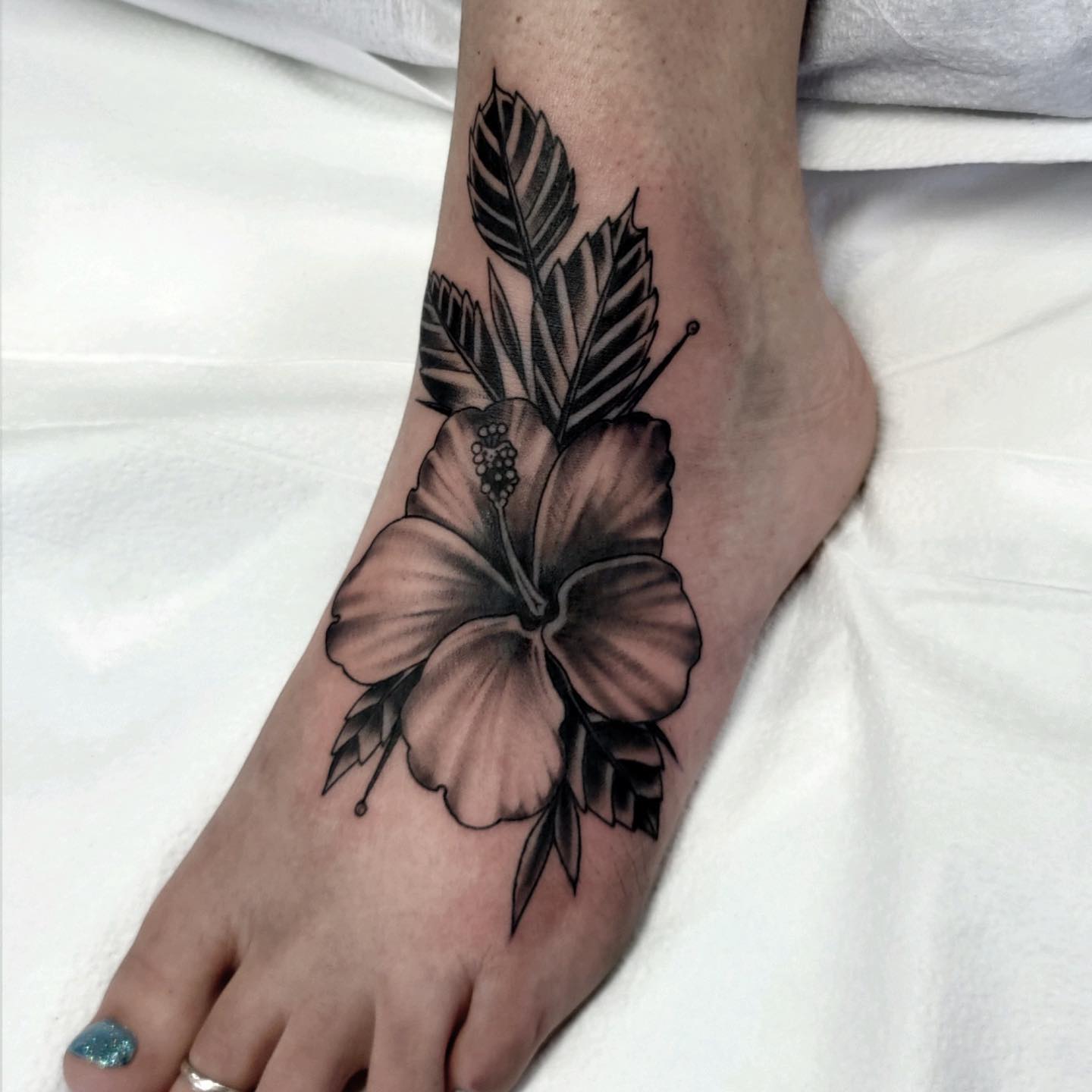 tatuaż z kwiatem hibiskusa na stopie