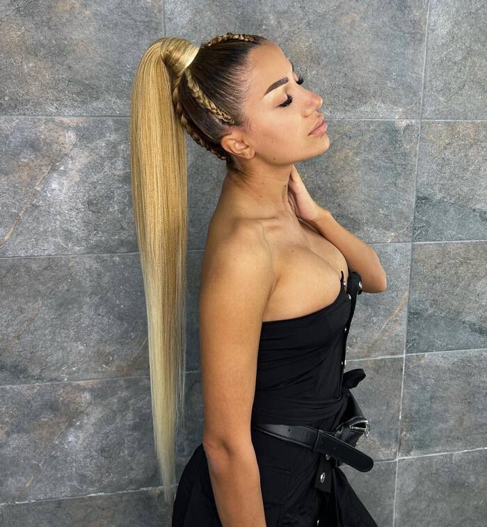 Woman with honey blonde hair styled in high ponytail