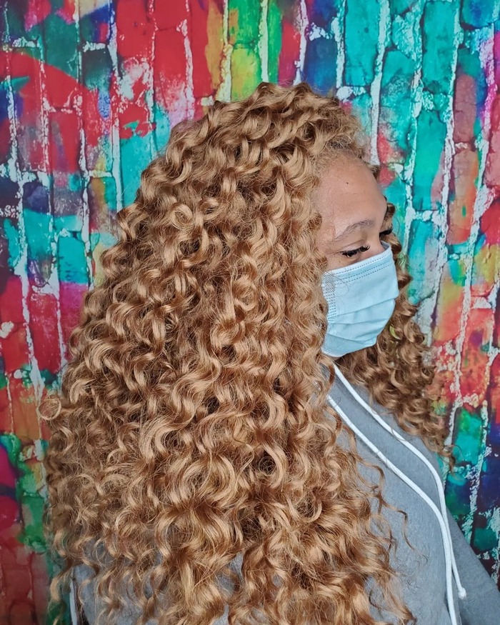 Hard curly locs in honey blonde color 
