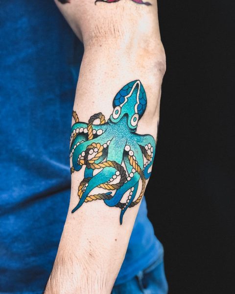 Niebieski tatuaż na przedramieniu ośmiornicy