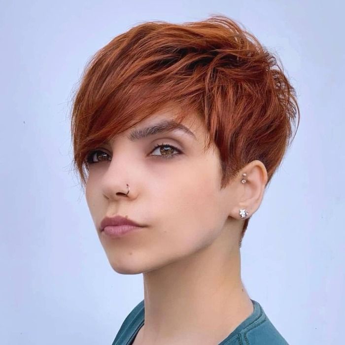 Photo of Woman With Red Pixie Bob Haircut With Bangs
