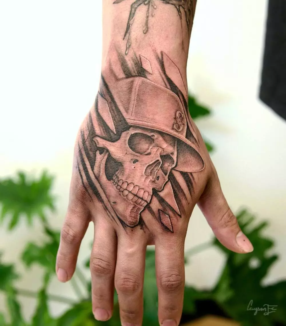A Close-up Photo of Black and Gray Skeleton Skull Hand Tattoo