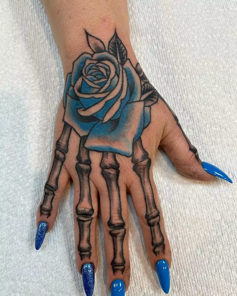 Blue Rose And Skeleton Hand Tattoo 