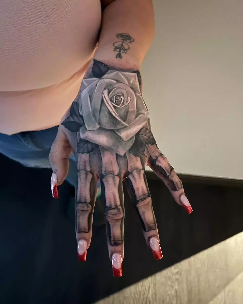 Female Skeleton and Rose Hand Tattoo