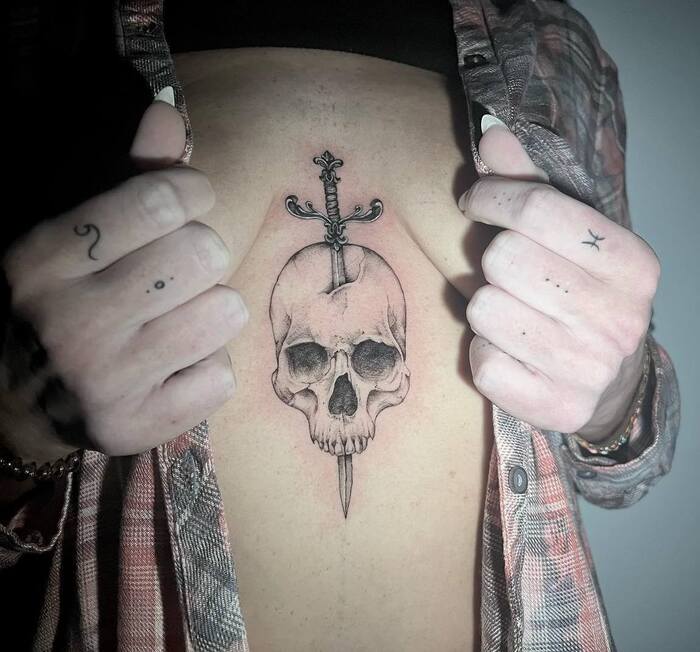 Skull and Knife Sternum Tattoo