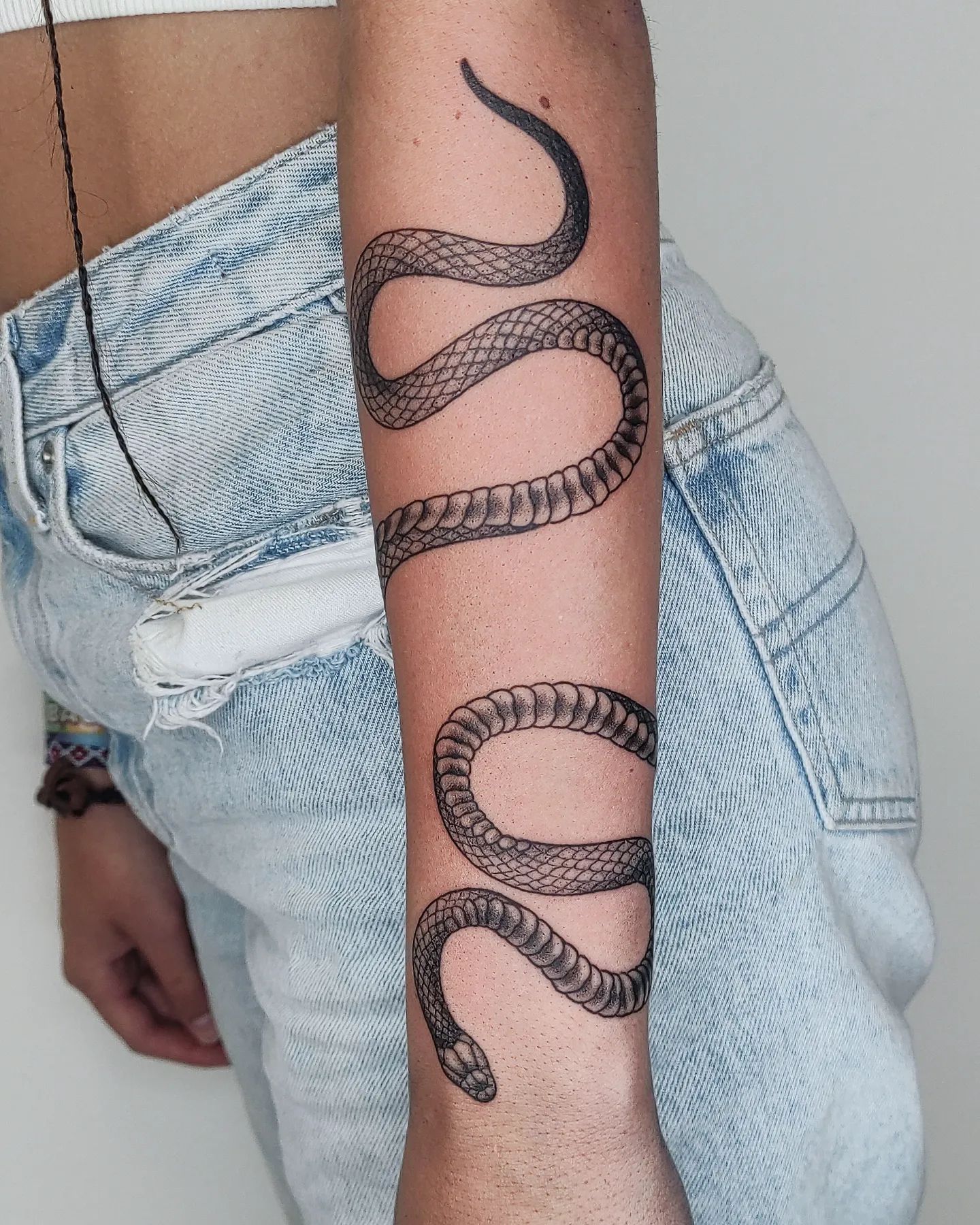 coiled snake arm tattoo