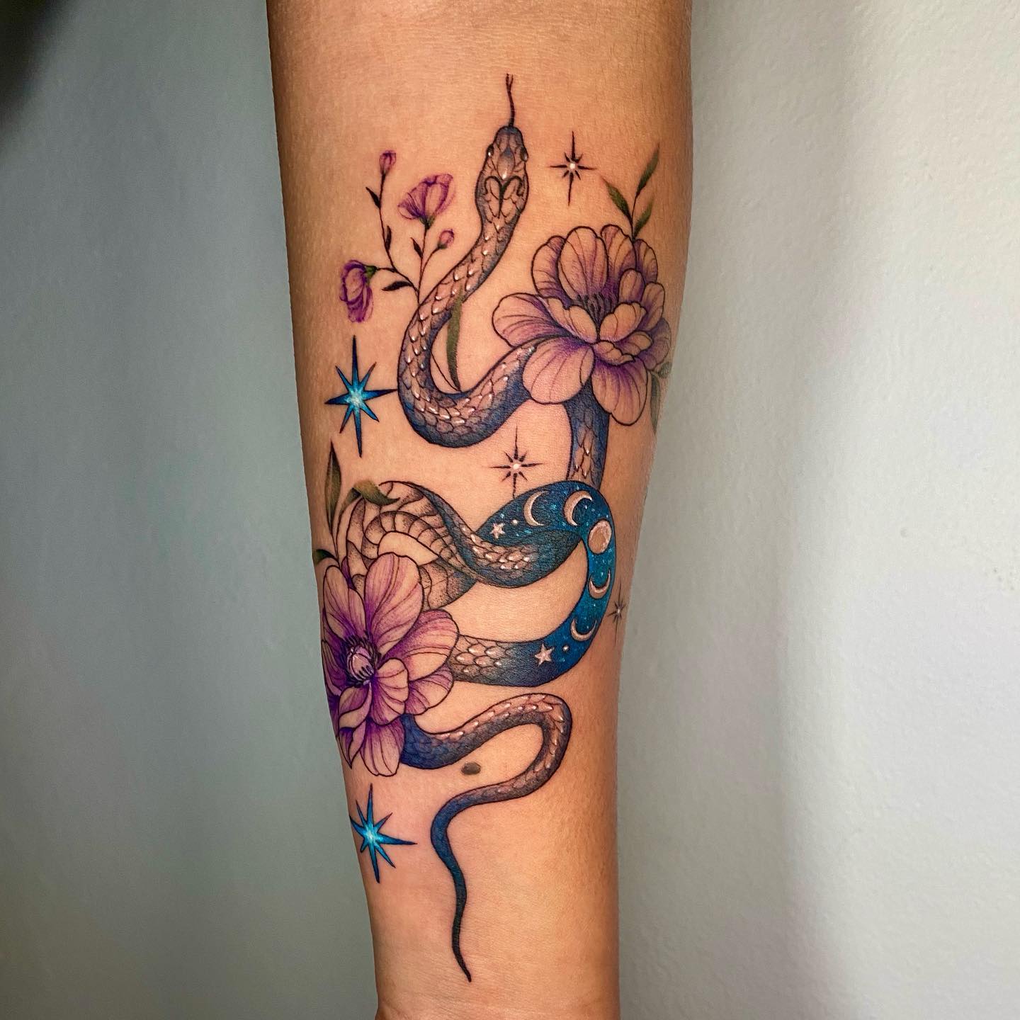 coiled snake arm tattoo