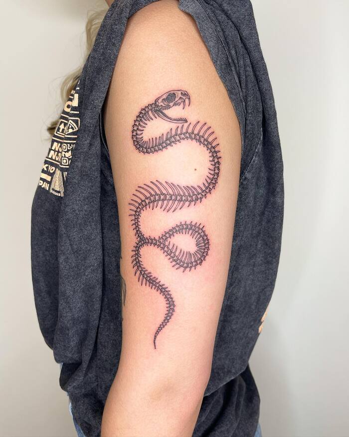 Close-up Image of the Realistic Snake Skeleton Arm Tattoo