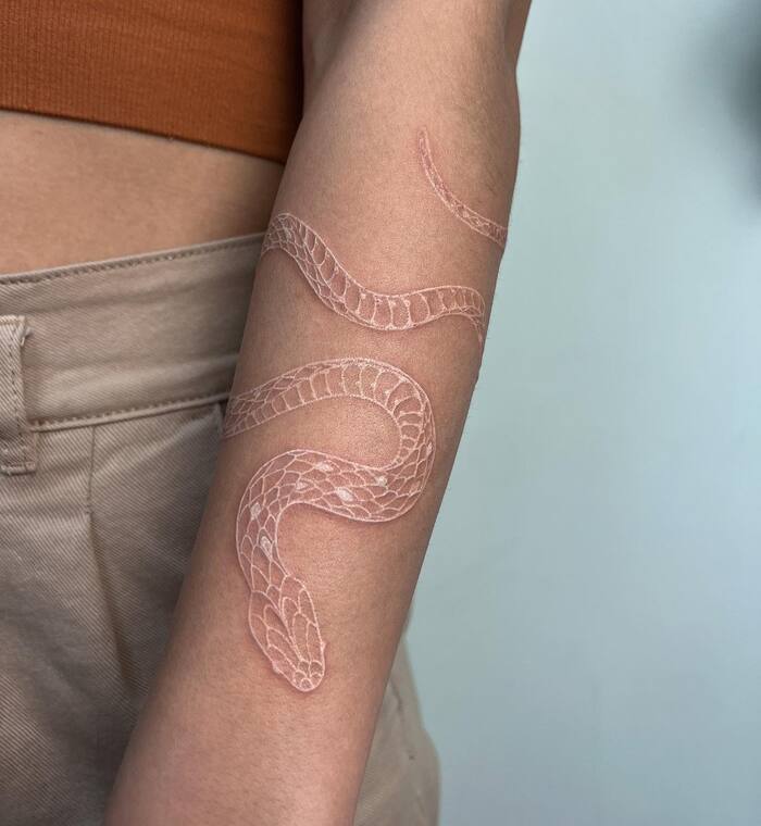 Close-up Image of the Minimalistic White Ink Snake Tattoo
