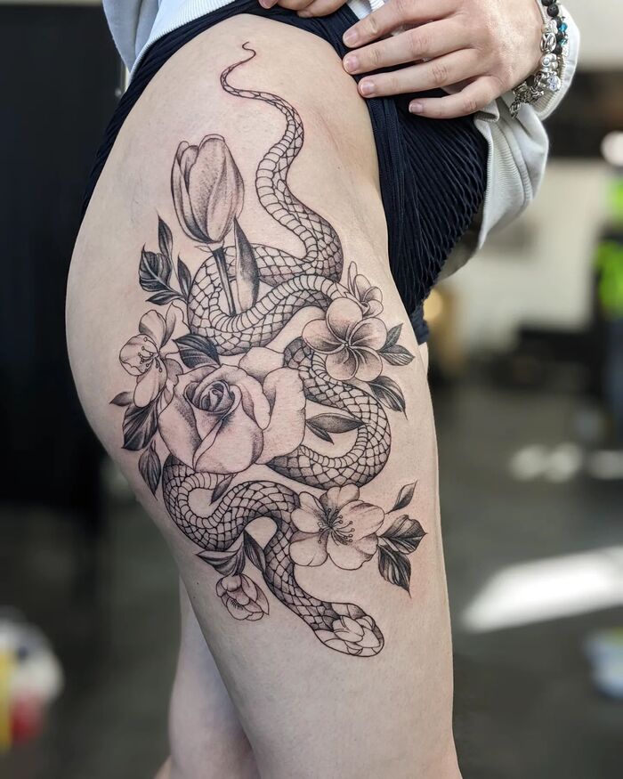 Close-up Image of the Sexy Snake and Flowers Hip Tattoo