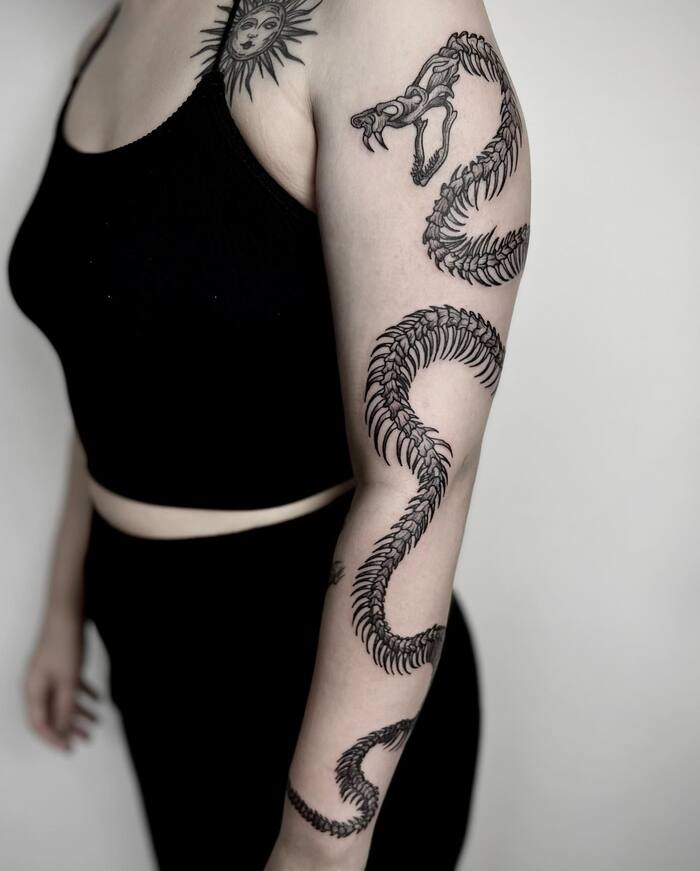Close-up Image of the Snake Skeleton and Sun Tattoo