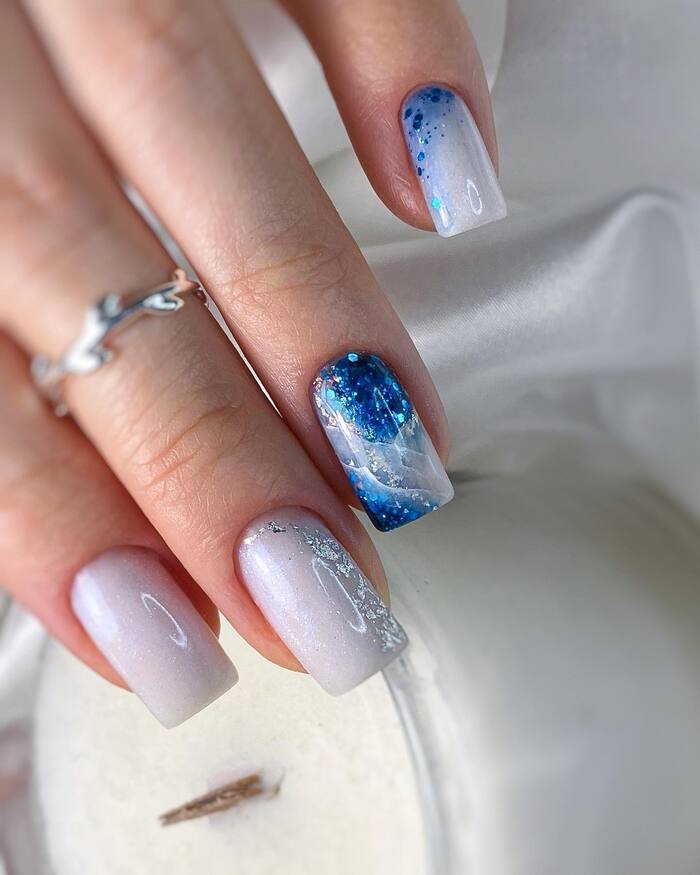 White Nails with Blue Blings