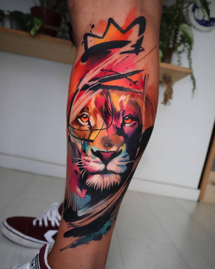 Watercolor tattoo of lion with black crown