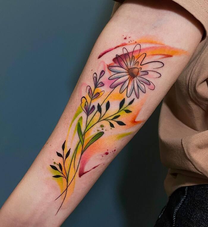 Watercolor tattoo of daisy blossom in fall colors