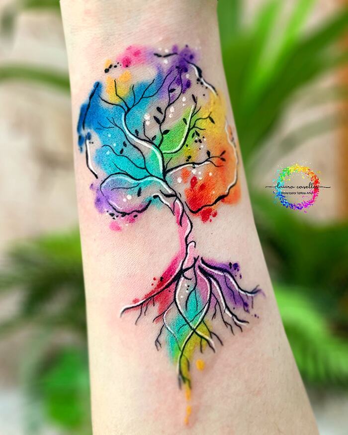 Tattoo of black fine line tree filled by multicolored watercolor splashes