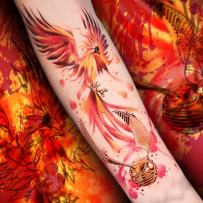 Watercolor tattoo of phoenix in red, orange and yellow inks