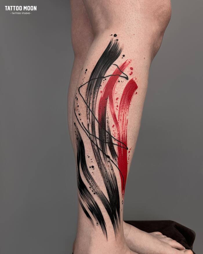 черно-красная акварельная тату на ноге