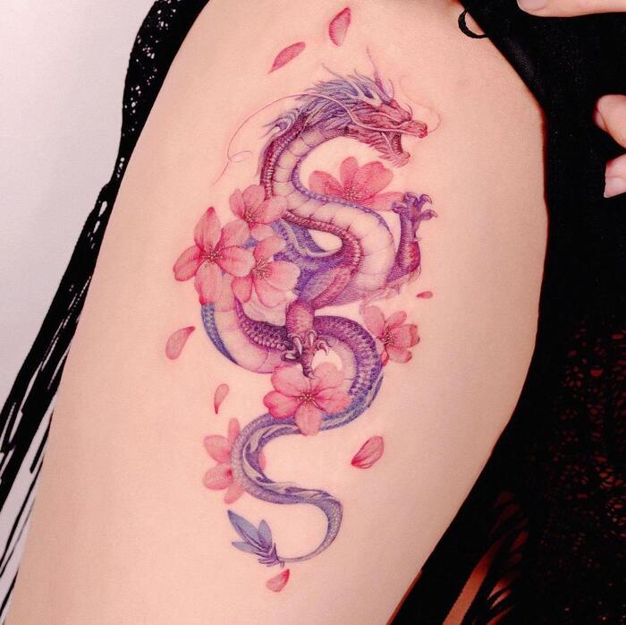 Watercolor tattoo of dragon surrounded by sakura blossom in purple and red