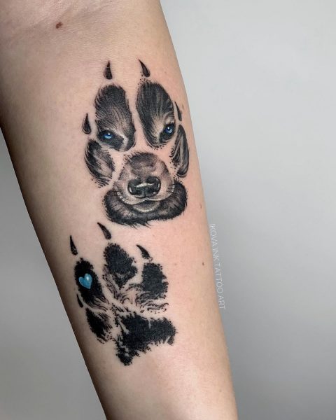 Realistyczny tatuaż z łapą wilka na przedramieniu